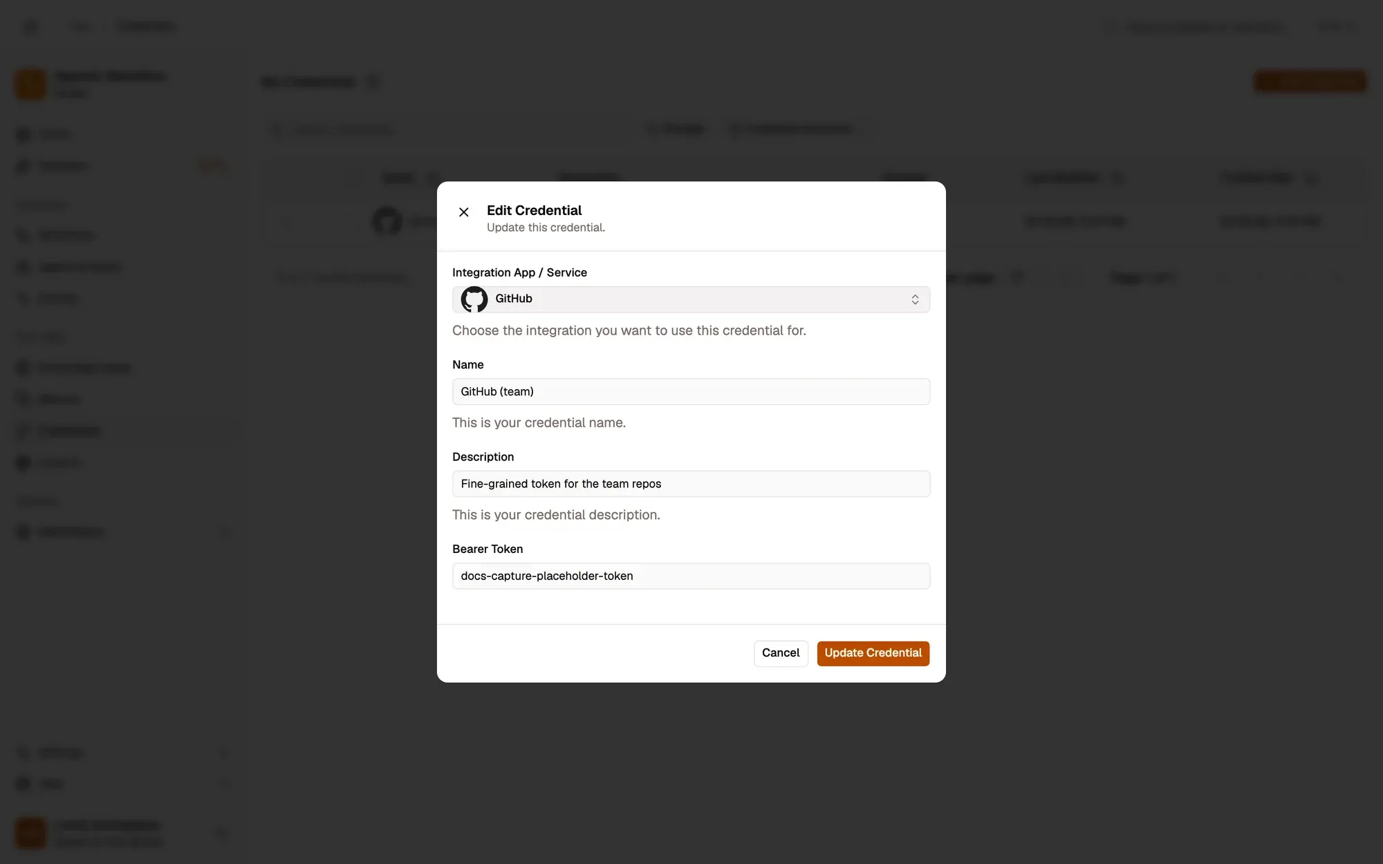 The Edit Credential dialog for a GitHub credential named GitHub (team): the Integration App / Service set to GitHub, the Name and Description fields, the Bearer Token field (a placeholder value), and Cancel and Update Credential buttons.