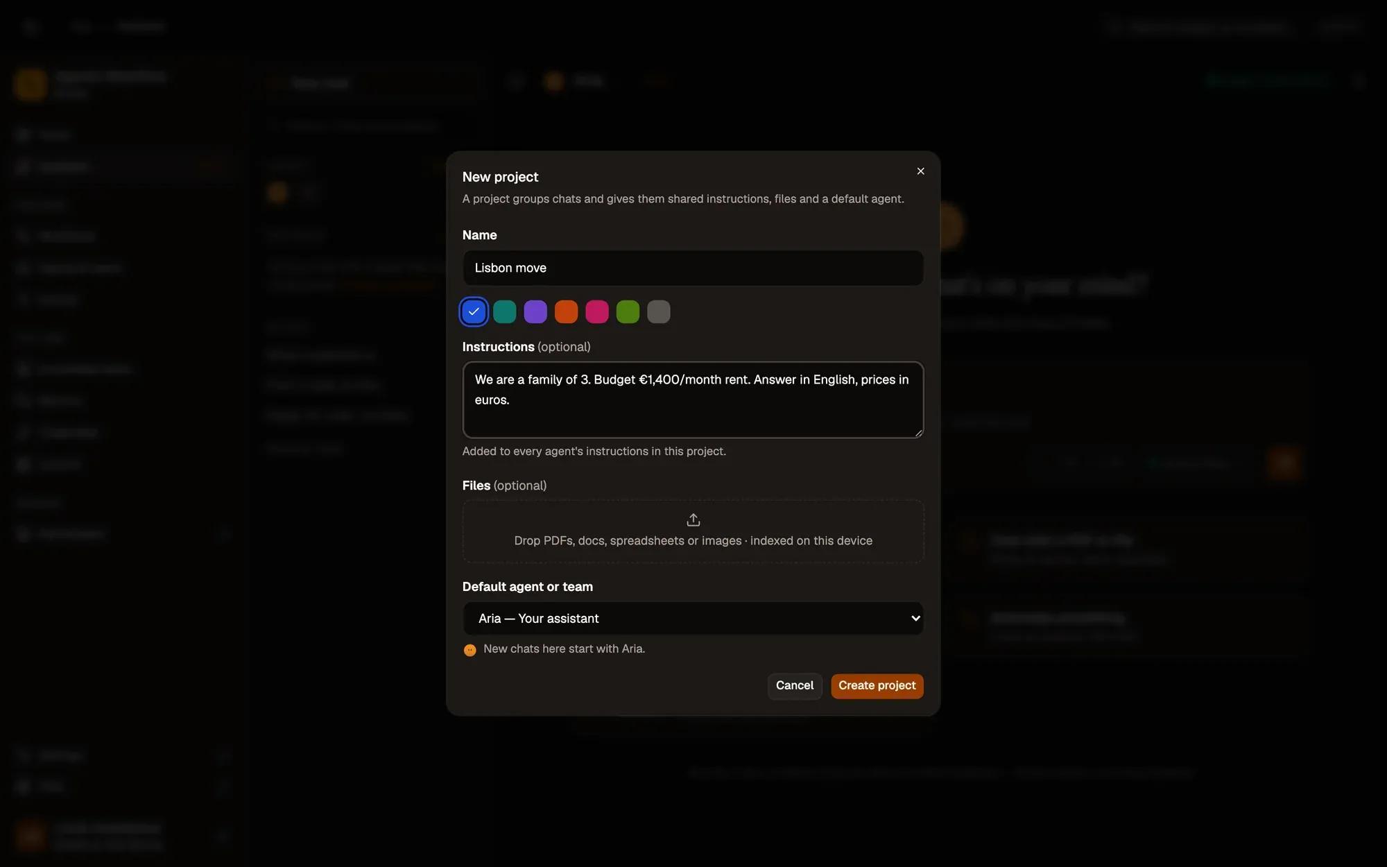 The New project dialog over the Assistant: Name (Lisbon move), a colour, Instructions about the family budget, a Files drop zone indexed on this device, Default agent or team set to Aria, and Cancel and Create project buttons.